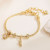 Золотистый браслет с подвесками-талисманами CJL20462