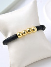 Браслет из темных матовых бусин с золотистыми вставками Z16393
