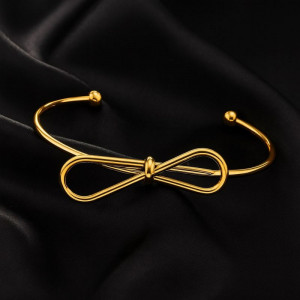 Золотистый браслет-кафф с центральным элементом в виде банта 1J12459CJJ