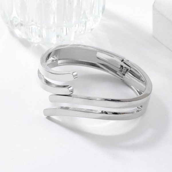 Браслет жесткий тройной разомкнутый из золотистой стали CJH74590