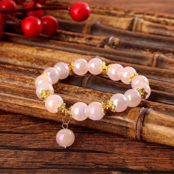 Браслет из розовых бусин с золотистыми разделителями CJH59294