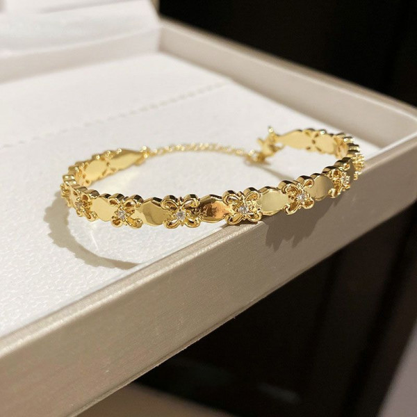 Золотистый жесткий браслет с цветочным орнаментом CJL19461