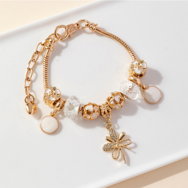 Золотистый браслет с подвеской-бантиком и жемчугом CJR68557