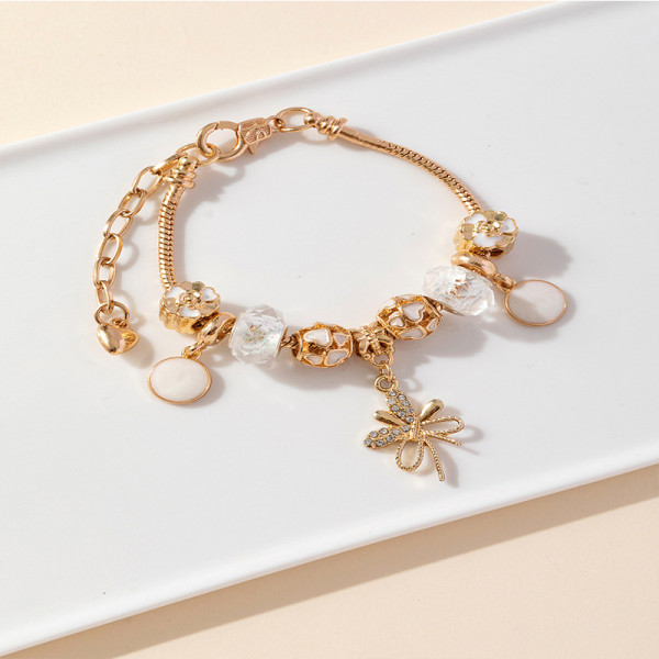 Золотистый браслет с подвеской-бантиком и жемчугом CJR68557