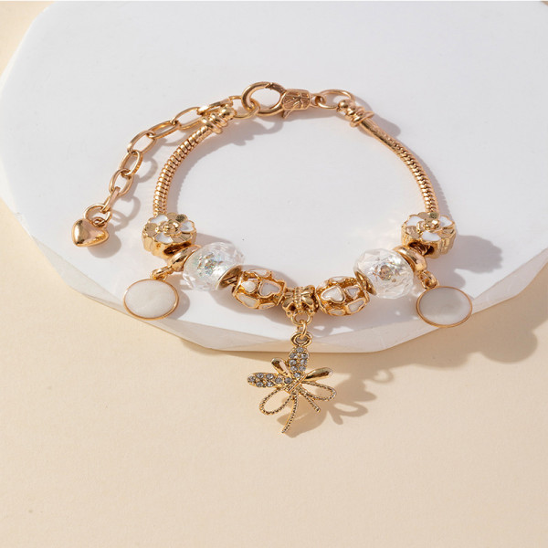 Золотистый браслет с подвеской-бантиком и жемчугом CJR68557